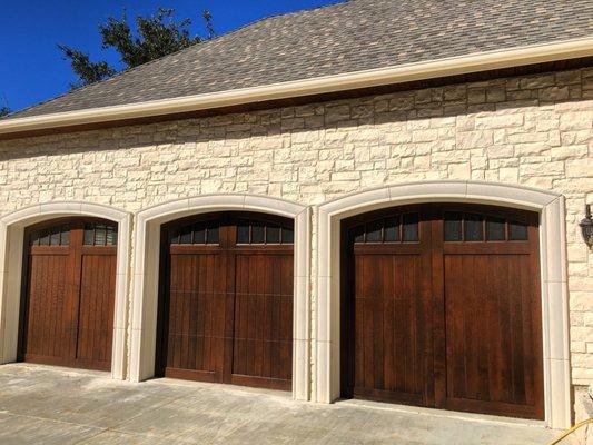 Clear cedar garage door with arched vertical glass.