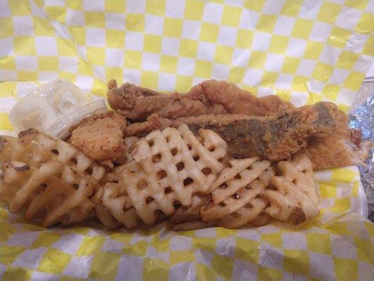 Fish dinner with waffle fries. Fish was cooked and seasoned well.