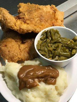 Fried pork chops,  potatoes and gravy,  and green beans