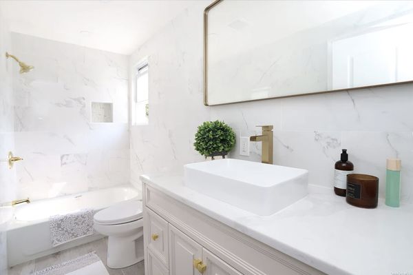 Brass and Marble Bathroom with custom vessel sink and custom countertop