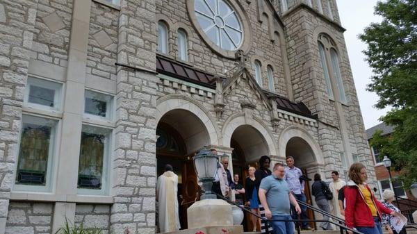 Front of church, as people exit following 11AM Mass.