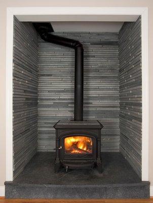 Soapstone firebox surround made from strips of Alberene soapstone