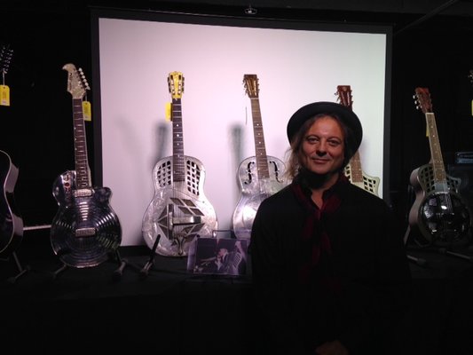 Standing with steel guitars owned by Johnny Winter