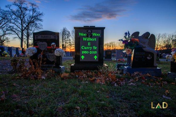 Woo Woo's memorial monument shining bright green throughout the cemetery.