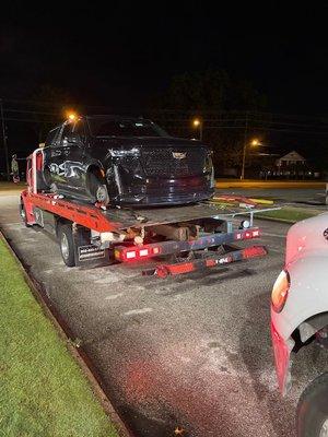 Towing an Caddy Escalade to the shop with a damaged front wheel - 1