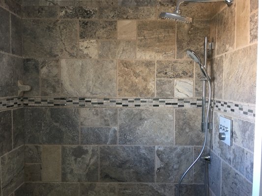 All travertine tile shower designed by the owner of Jameson Remodeling