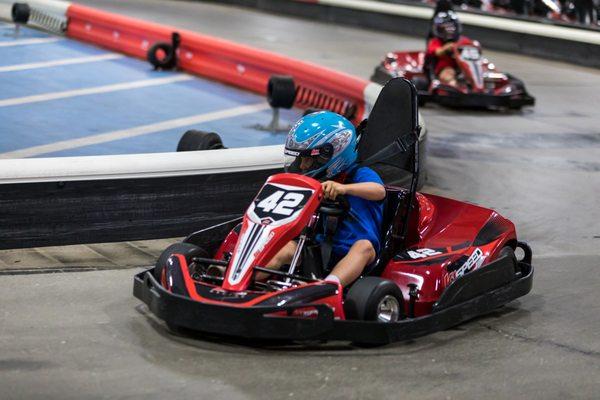 A kid races a junior kart at K1 Speed