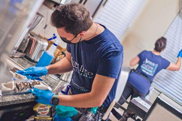 Heavy scrubbing the kitchen appliances for a Deep Clean