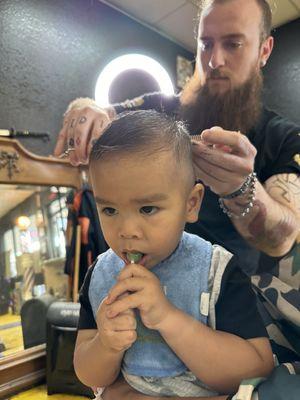 Tanner hooking my son's hair up while he drools all over me.  it's the only time he gets a lollipop.