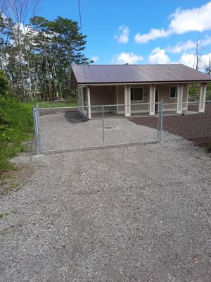 Fenced yard with front gate and a rear pedestrian gate