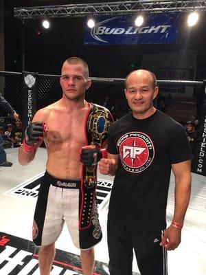 Kenya with his student Adam Piccolotti after Adam won the Dragon House lightweight belt at Dragon House 18.