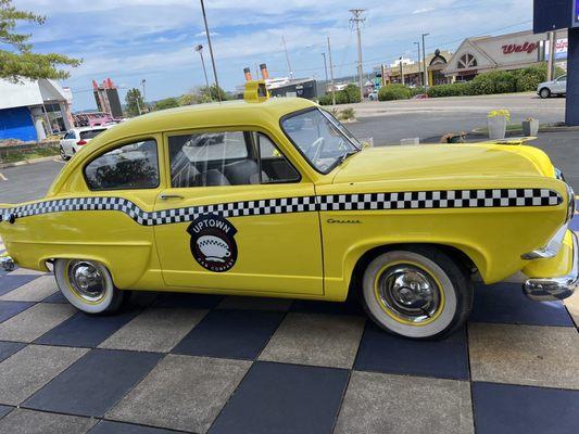 Car out front of restaurant.