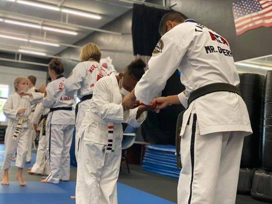 Students receiving a new belt