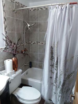 Renovated bathroom, vinyl flooring, custom paint, ceramic tile, install new deeper tub,and fixtures, commode, and sink