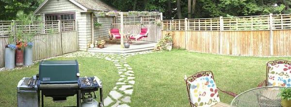 Back Yard Oasis / lawn, stone walk, deck, pergola, planters, and fence designed and built by Wish List.