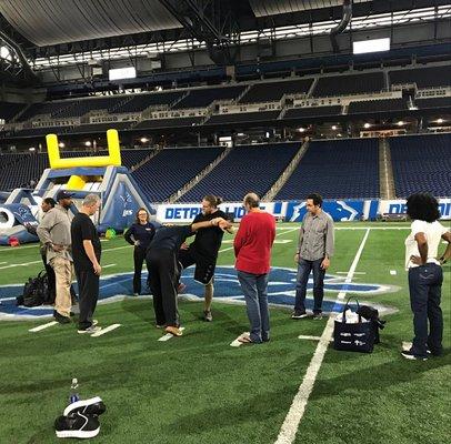 MKG Detroit Head Coach Kurt Cornwell teaching self defense on the 50 yard line of the Detroit Lions' Ford Field.