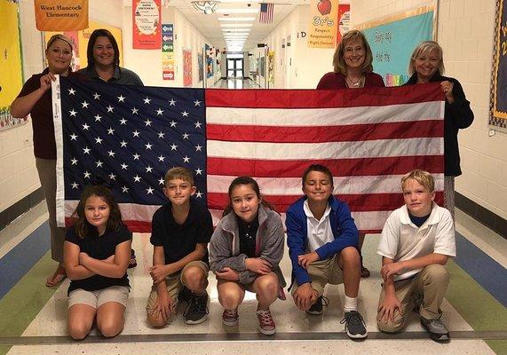 WoodmenLife Representatives Elizabeth Ladner and Kendra Shipman presented West Hancock Elementary with a 5x8 American Flag.