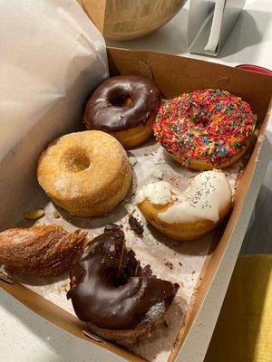 Sugar cronut with custard, sugar, chocolate, sprinkles, lemon poppy & chocolate covered cronut.