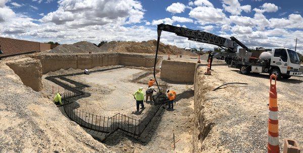 Pouring footings for a new basement using a concrete belt.