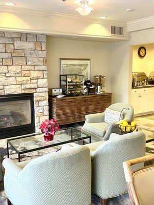 Nice lobby fireplace area for eating the offered breakfast, this shows just a portion of the food area with breads to toast.