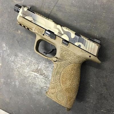 Smith & Wesson M&P featuring our Super Dragon slide cut, Kryptek frame stippling and a multi-color cerakote refinishing job.