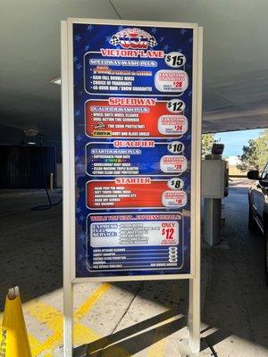 Sign showing service prices. The options for the full service are not covered and are also on the touch screen where you pay for the wash.