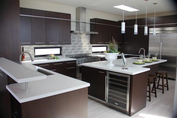 Modern kitchen design quarter sawn walnut doors and stainless steel inlay. Design by Hampton woodwork.