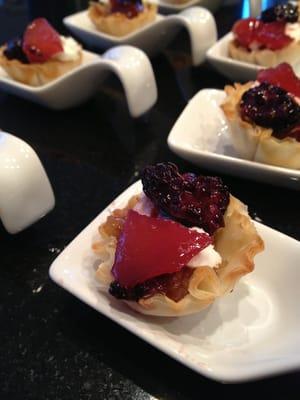 Grilled onion, goat cheese, and fruit canapé.