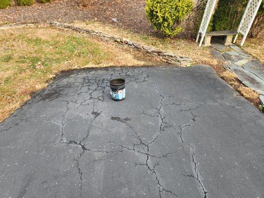 Getting ready to spread tar into cracks