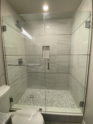 Frameless shower enclosure