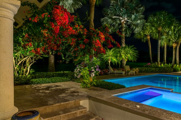 The tropical beauty of this estate home in Palm Beach Gardens shines at night with professionally designed and installed landscape lighting.