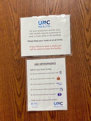 Reminders on exam room door. Note: masks are no longer required, only recommended.