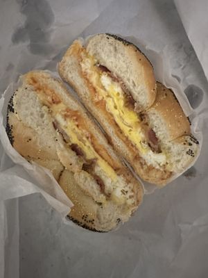 Bacon egg and cheese on a roll with ketchup