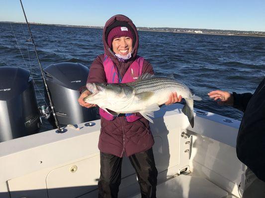 Daughter with huge Striped Bass