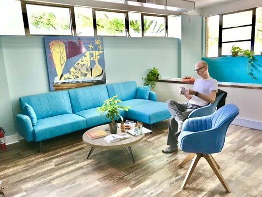 Tai chi instructor James Jeffers relaxes in the lounge with local artwork by Daniel Green