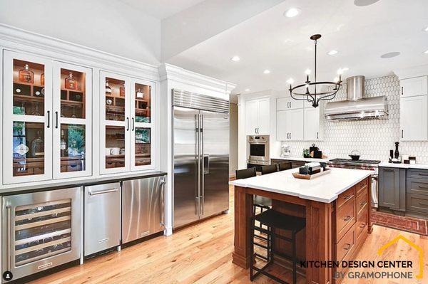 The wood tones work wonderfully with the stainless steel and white/grey cabinetry to bring a softness to this light and airy kitchen!