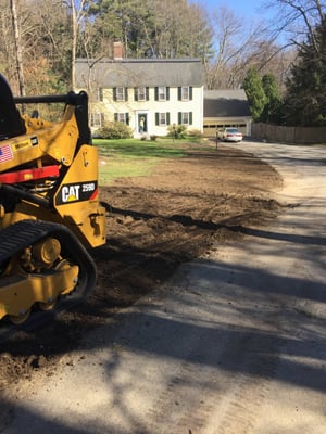 Finish grading after new water line installation.