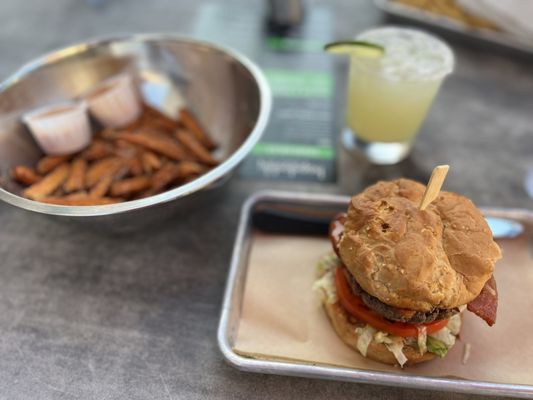 Buffalo bill with gf bun, sweet potato fries, house margarita on the rocks with salt