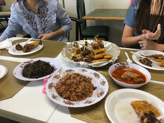 Sampler containing pork, chicken legs, fried plantains and rice