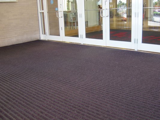 Vinyl roll goods solutions entrance matting for Vestibules: Ultra Entry™ shown here with carpet scraper inserts.