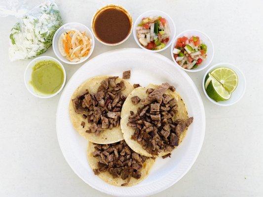 Three asada tacos ($9.00) with all of the toppings.