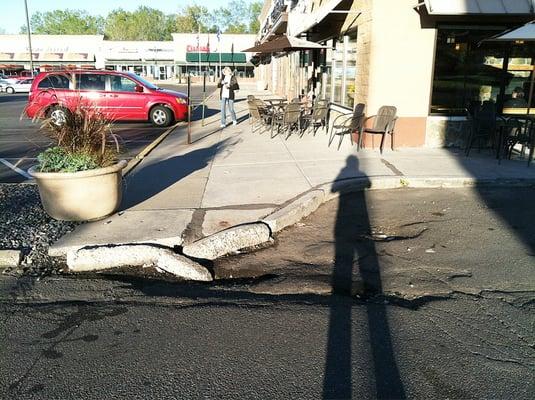 Broken curb, low pavement holds rain etc, ala lake caribou