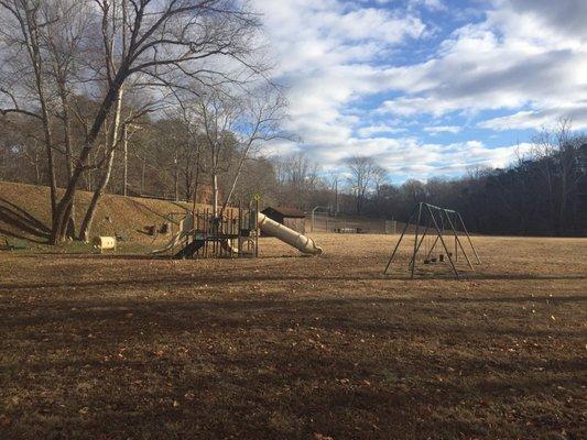 Other side of bridge there is some playground equipment