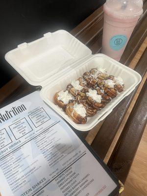 Donuts with coconut and chocolate drizzle and a little whipped cream. My strawberry banana protein shake!