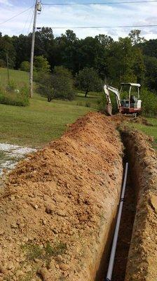 Installing a water line with our mini excavator.