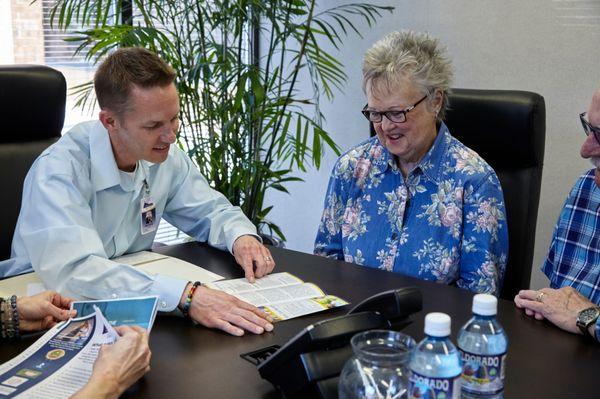 Owner Mike Marley with future clients discussing their plan of care.