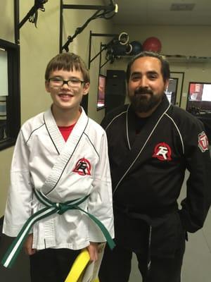 My son receiving his green L1 belt at the awards ceremony from his instructor.  So proud of him!