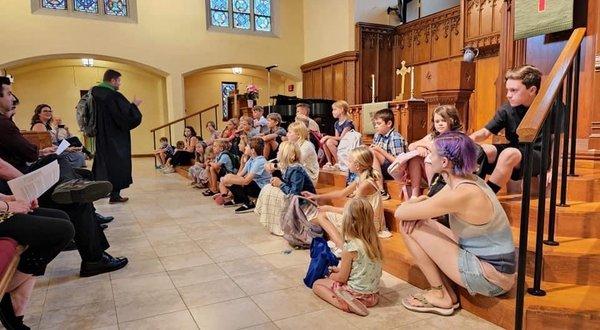 Blessing of the Backpacks, one way we welcome, nurture, and encourage kids in worship as they start the new school year.