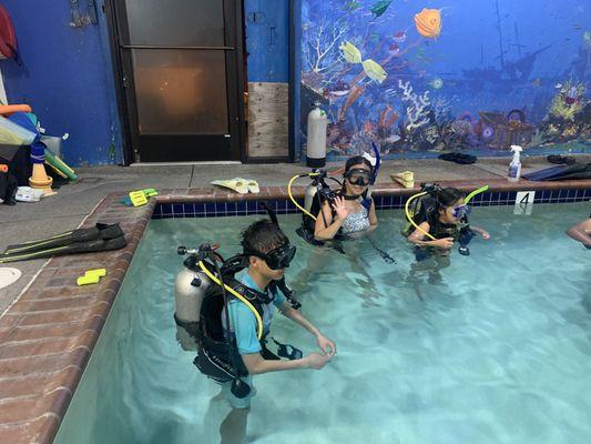 My girlfriend and our children doing the pool exercises for our open water certification.