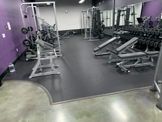 Various power racks and adjustable benches and dumbbells.